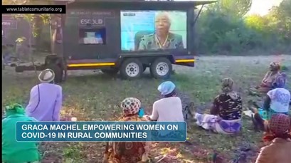 A photo of women sitting on the ground outside looking at a screen. Title text reads "Graca Machel Empowering Women on COVID-19 in Rural Communities"