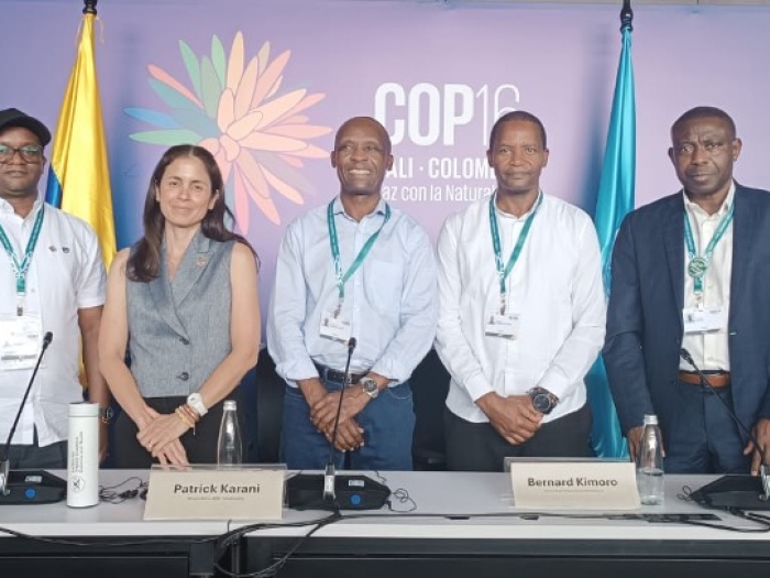 A group of 5 people smiling and presenting at the COP16 coference in Colombia.