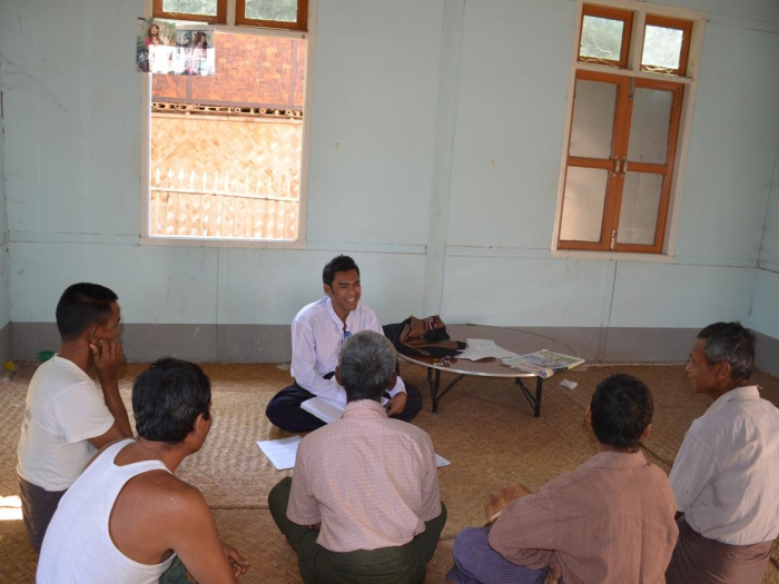 Aung Tun Oo sits with farmers from the Ayeyarwaddy region, Myanmar